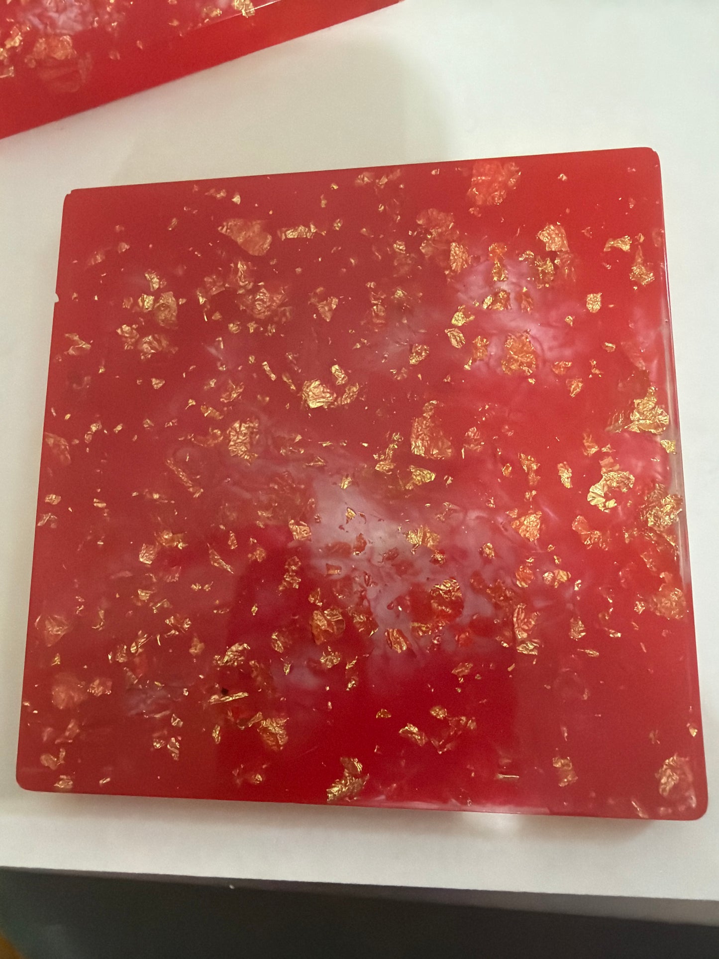 Red epoxy coaster with gold flakes